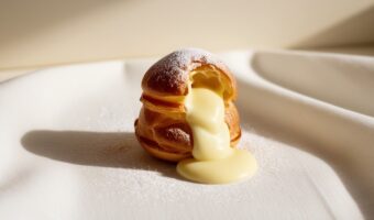 Leonardo_Phoenix_09_A_delicate_goldenbrown_profiterole_sits_at_1