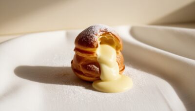 Leonardo_Phoenix_09_A_delicate_goldenbrown_profiterole_sits_at_1